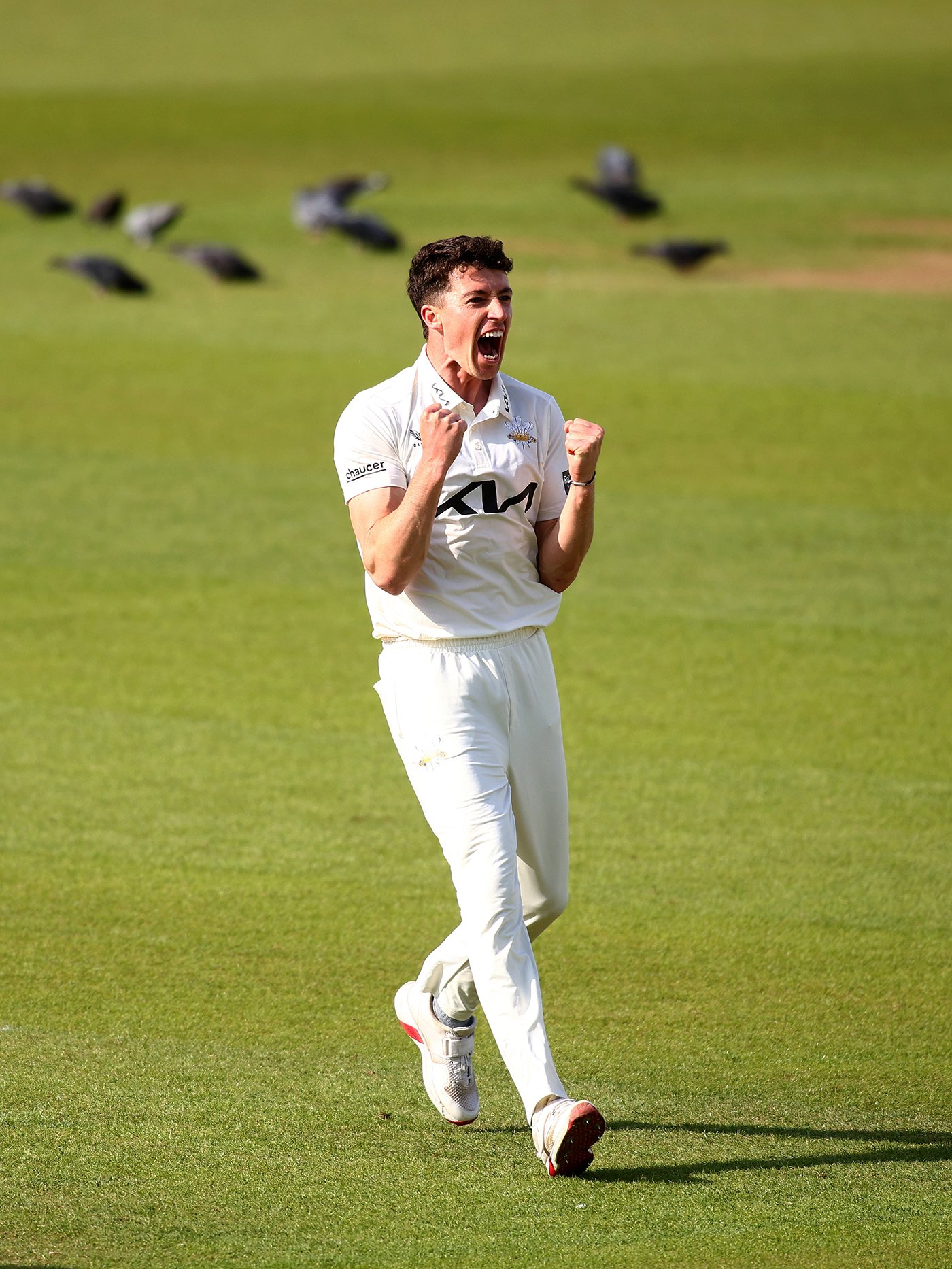 Fisher strikes between showers but weather frustrates Surrey